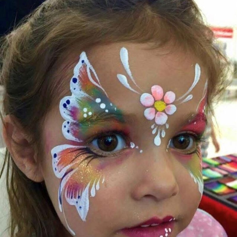 Girl with colorful butterfly and flower face paint