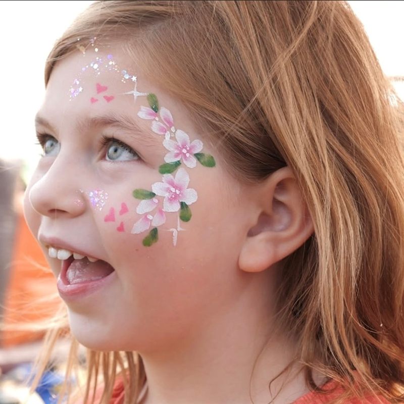 Girl with pink floral glitter face paint